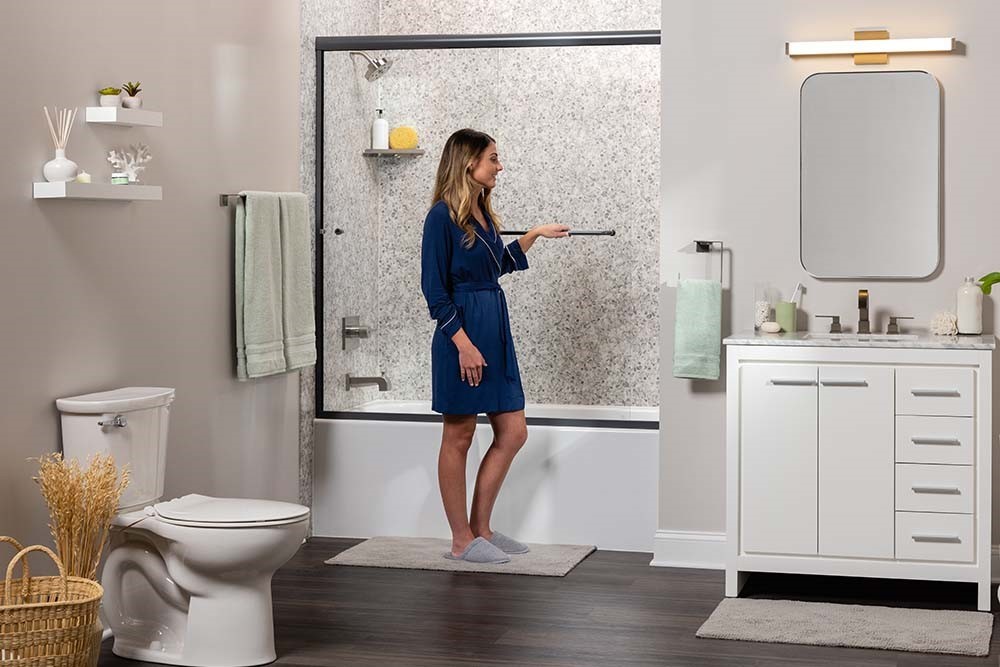 Bathroom remodel with bathtub and shower combo, sliding glass doors, modern vanity, and updated fixtures.