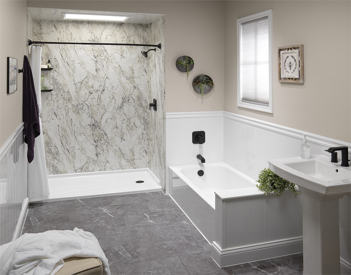 Bathroom remodel with bathtub and walk-in shower, marble-style walls, black fixtures, and modern design.